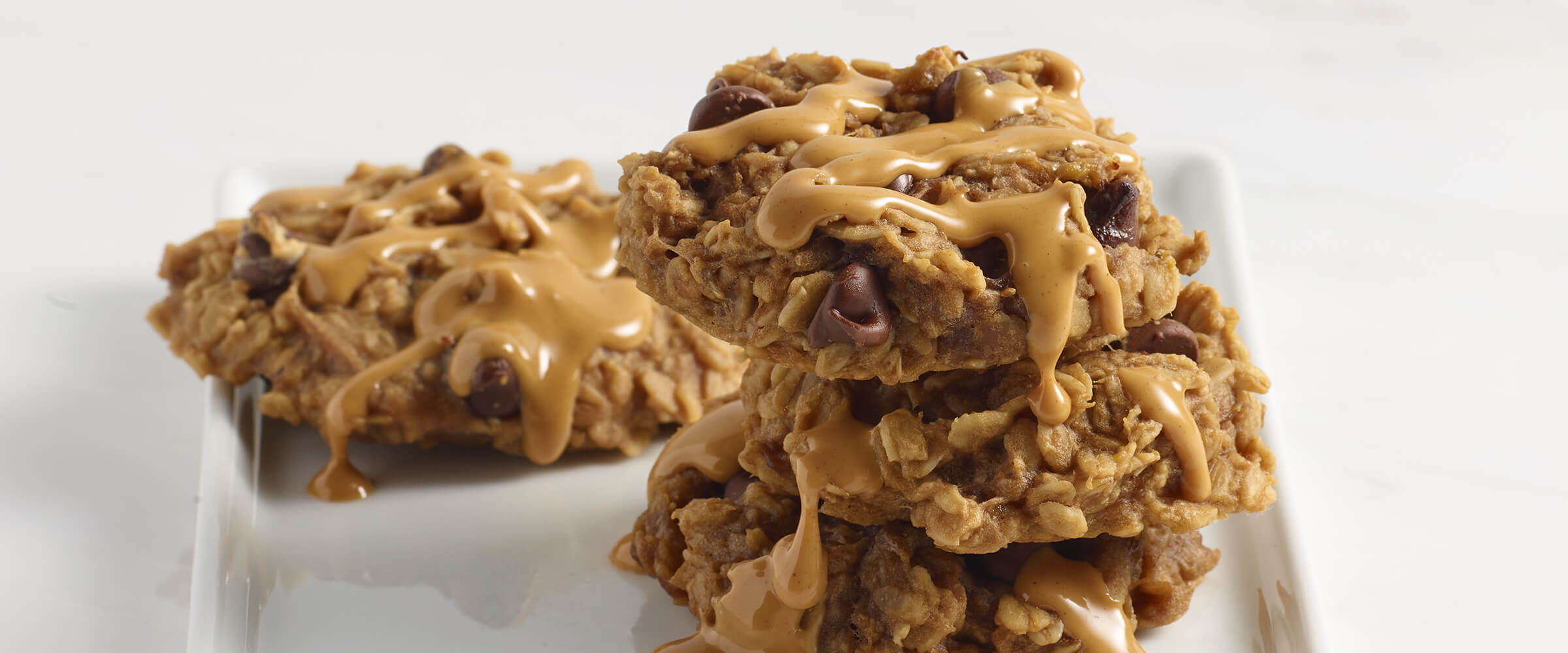 Peanut butter oatmeal cookies on a white square plate