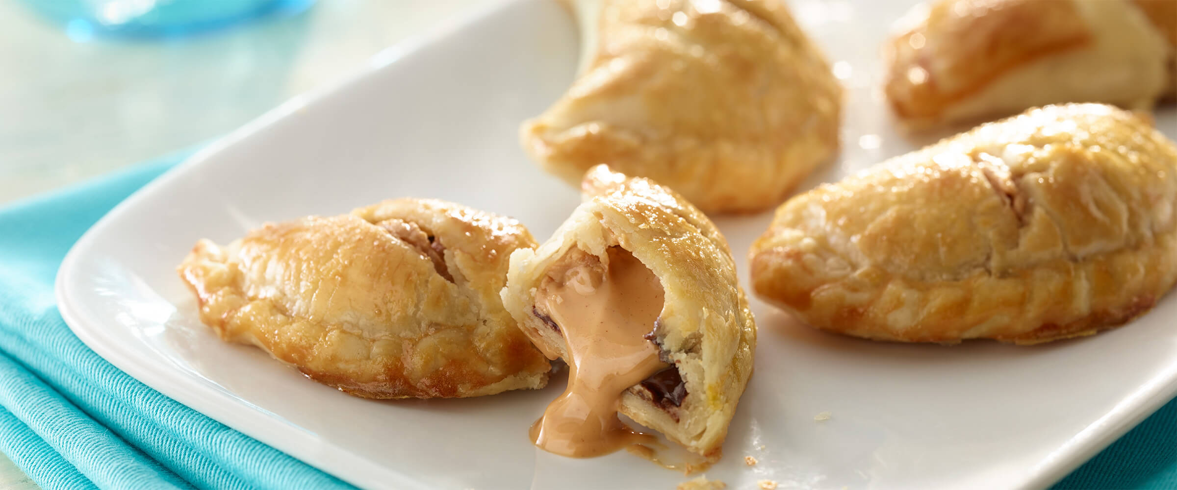 a broken crescent roll with melted peanut butter an chocolate visible