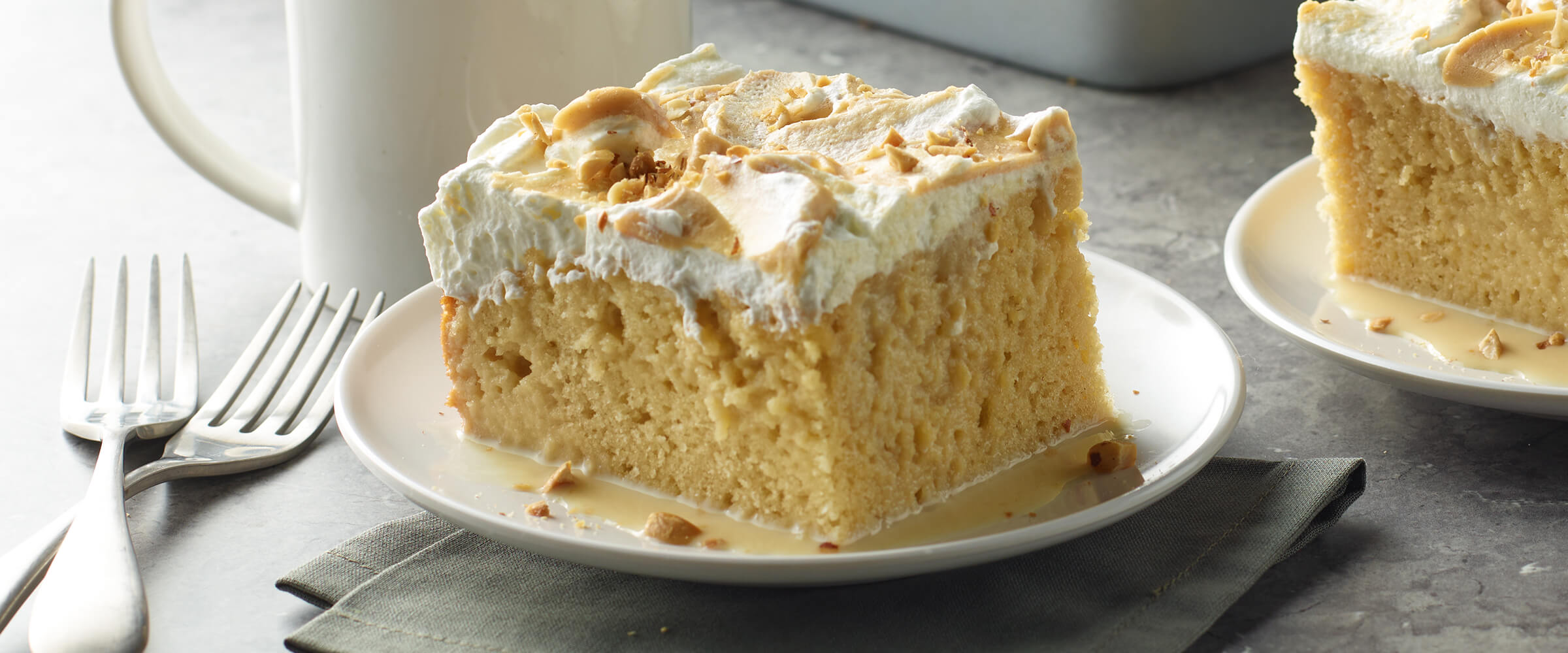 A slice of peanut butter tres leches cake on a small white plate