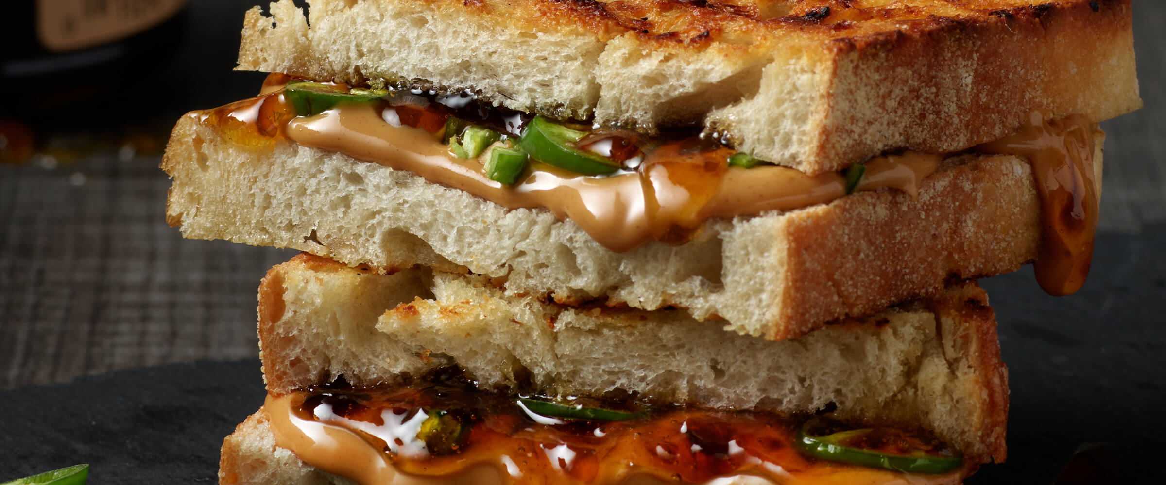 Peanut Butter and Jalapeno Sandwich cut in half and stacked on top of each other