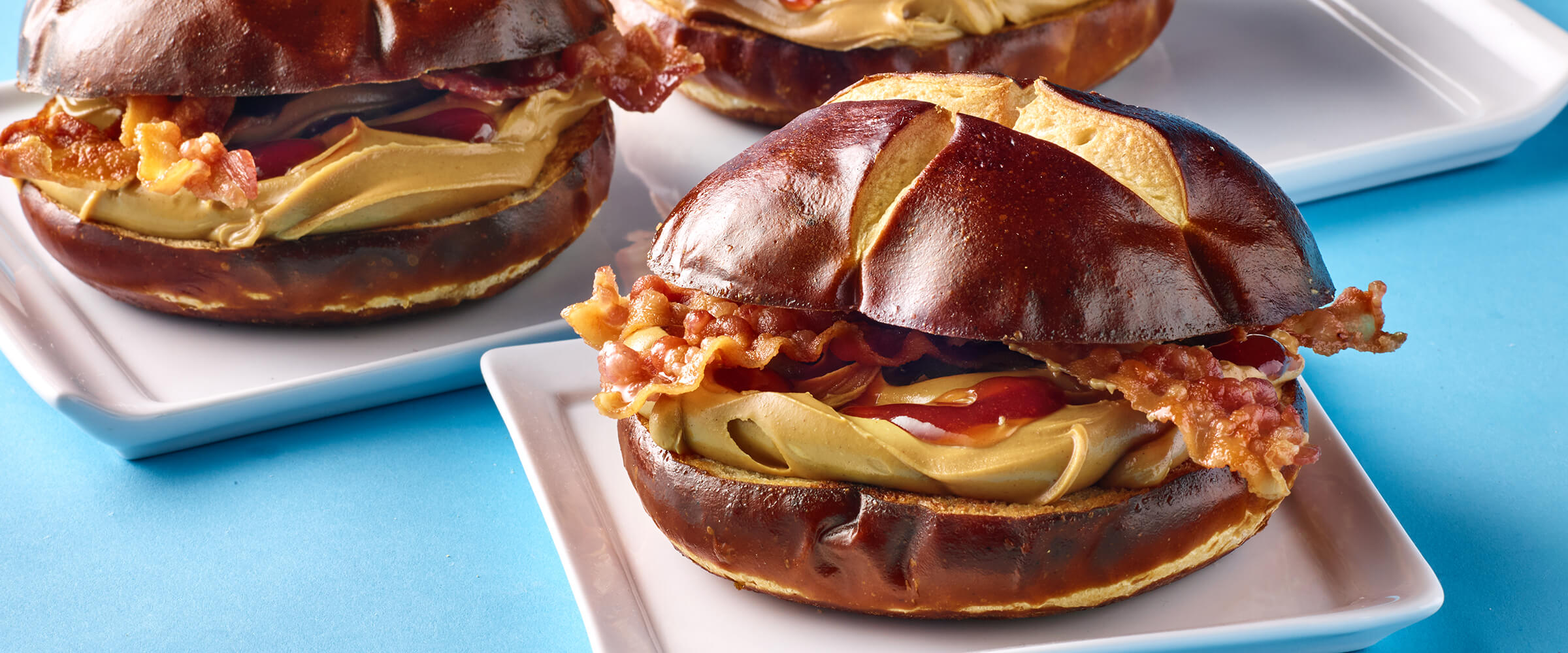 Peanut Butter Bacon and Jelly on a pretzel bun