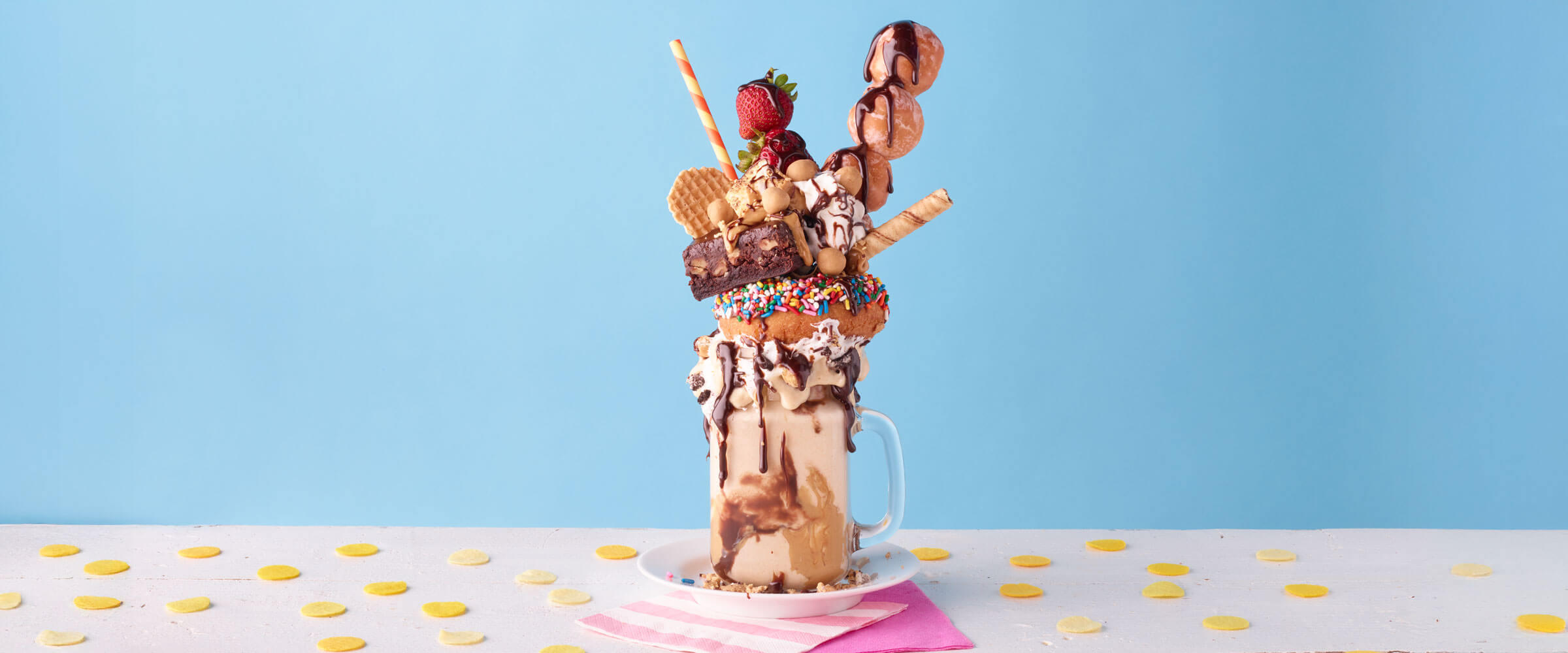 Over-the-Top Milkshake on a white surface with a pink napkin