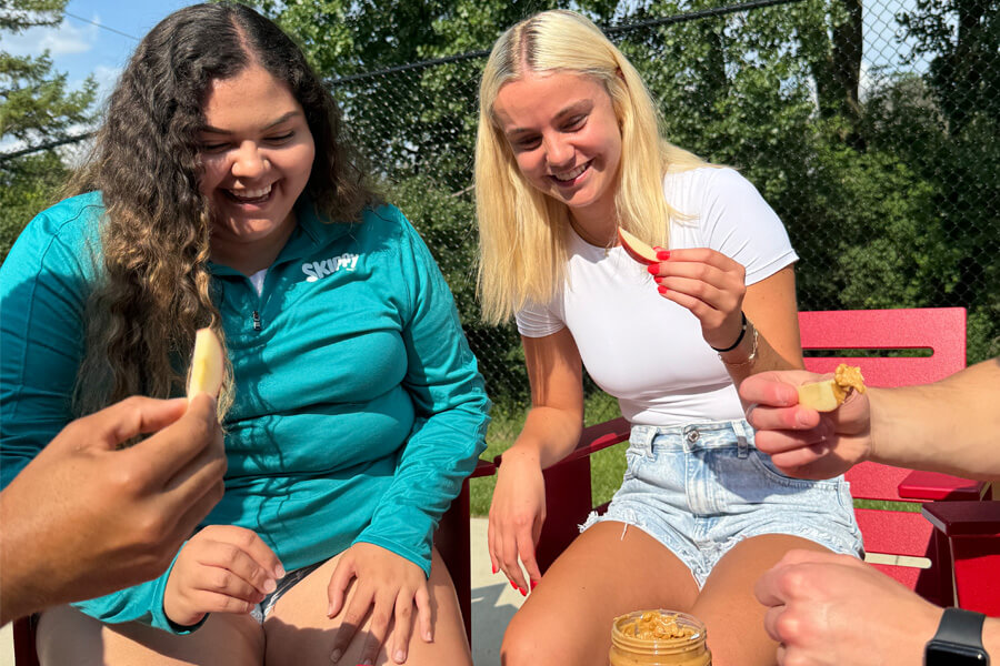 group of peanut butter fans eating fruit & peanut butter