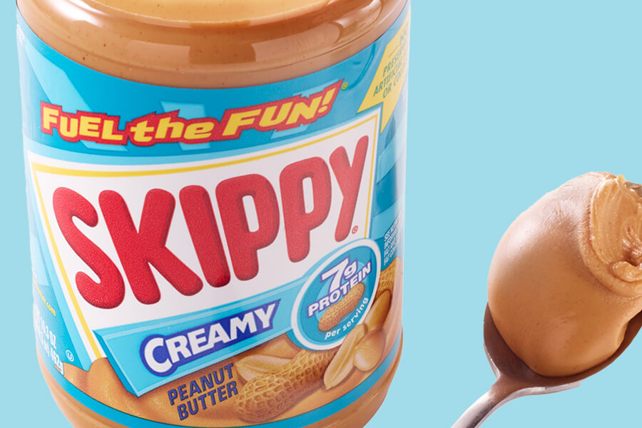 jar of creamy skippy with spoonful of peanut butter