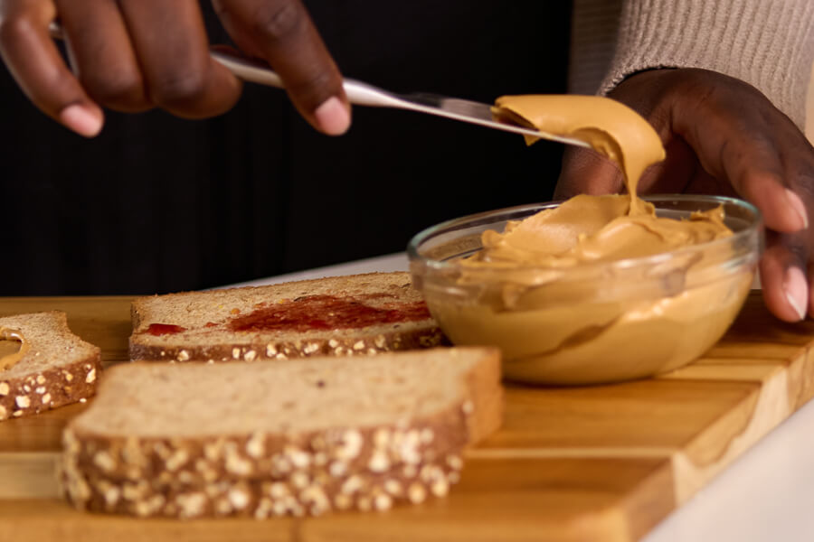 hands with knife & p.b. sandwich