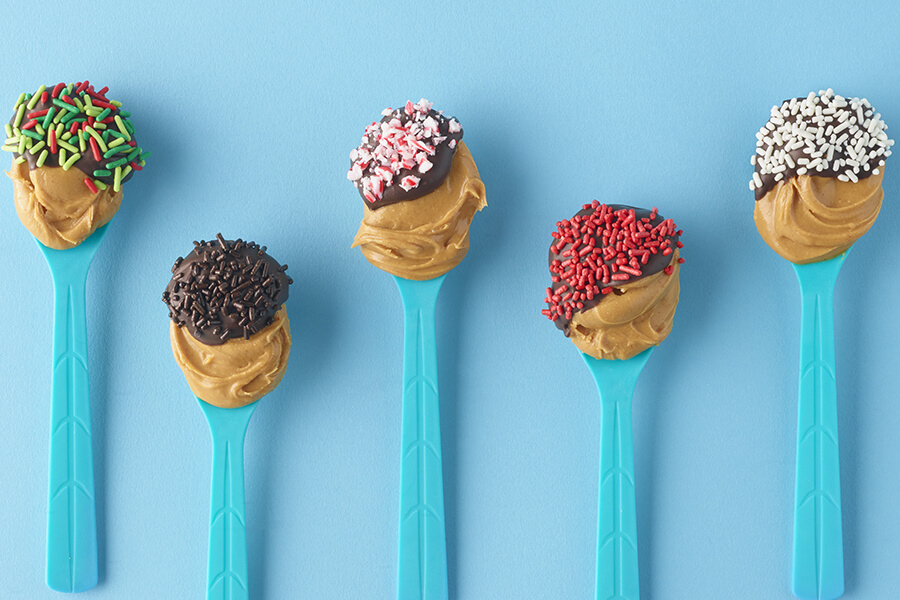 spoonfuls of peanut butter with colored sprinkles & toppings