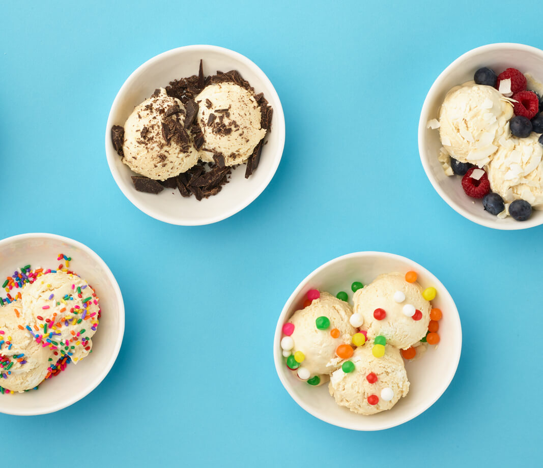 four bowls of ice cream with various toppings